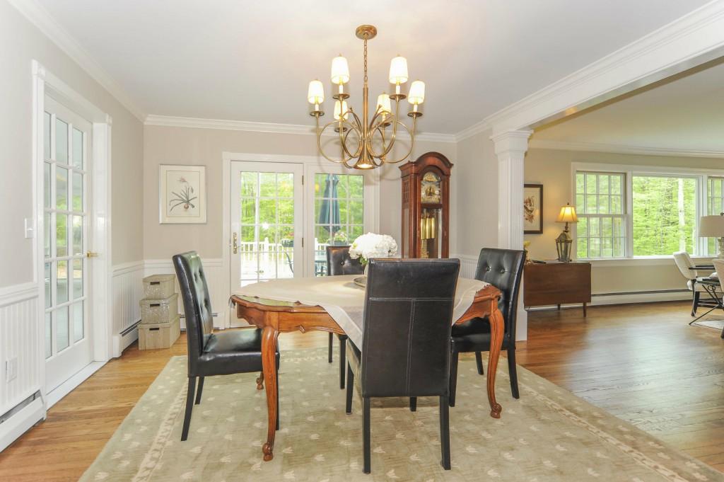 719 Cheese Spring Road New Canaan, CT 06840 - Photo 8 of 24 a view of a dining room with furniture a chandelier and wooden floor