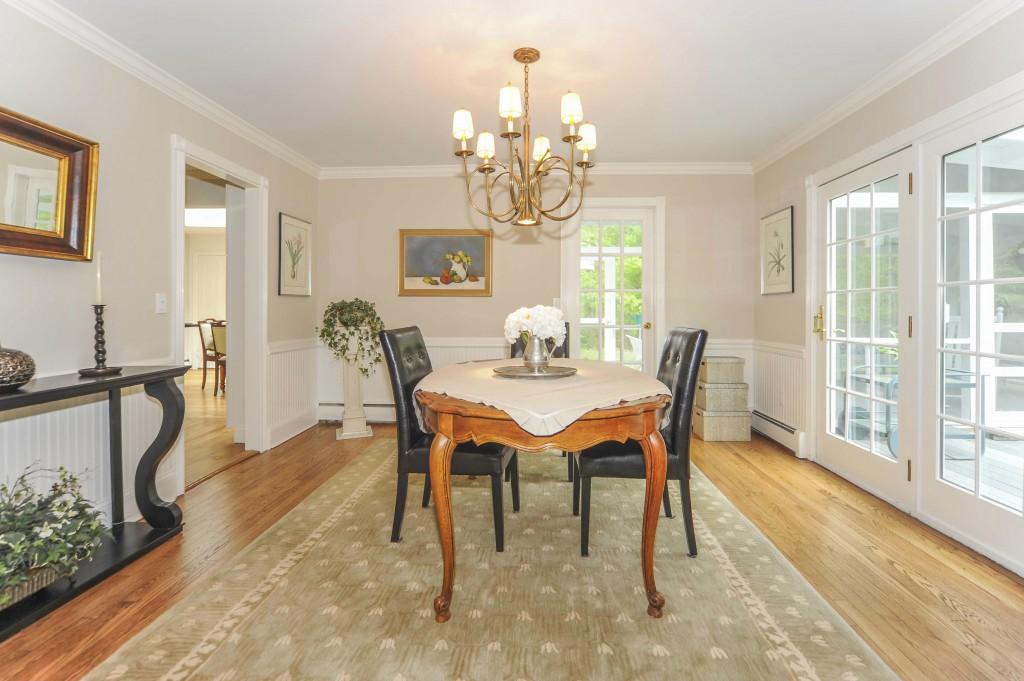 719 Cheese Spring Road New Canaan, CT 06840 - Photo 9 of 24 a dining room with furniture a chandelier and wooden floor