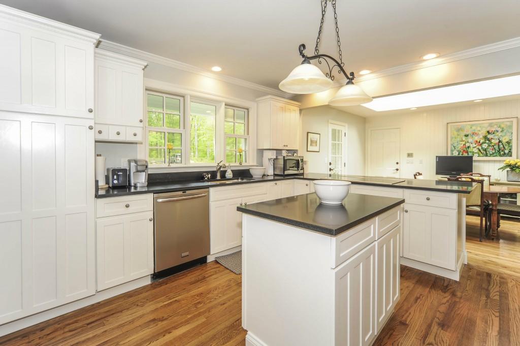 719 Cheese Spring Road New Canaan, CT 06840 - Photo 10 of 24 a kitchen with a sink stove and cabinets
