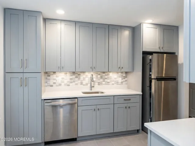 a kitchen with a sink appliances and cabinets
