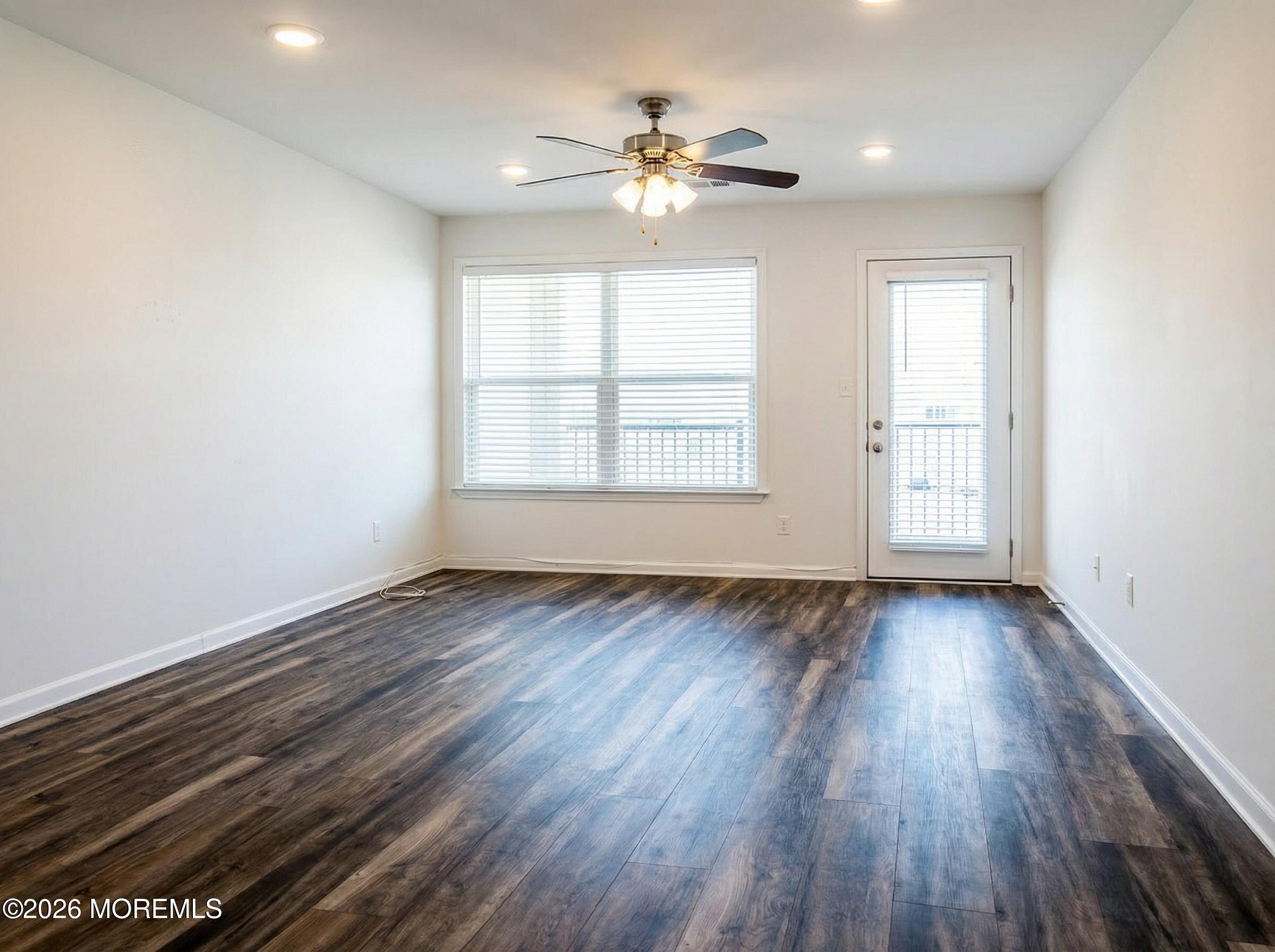 345 Sequoia Court Howell, NJ 07731 - Photo 4 of 4 an empty room with wooden floor and windows