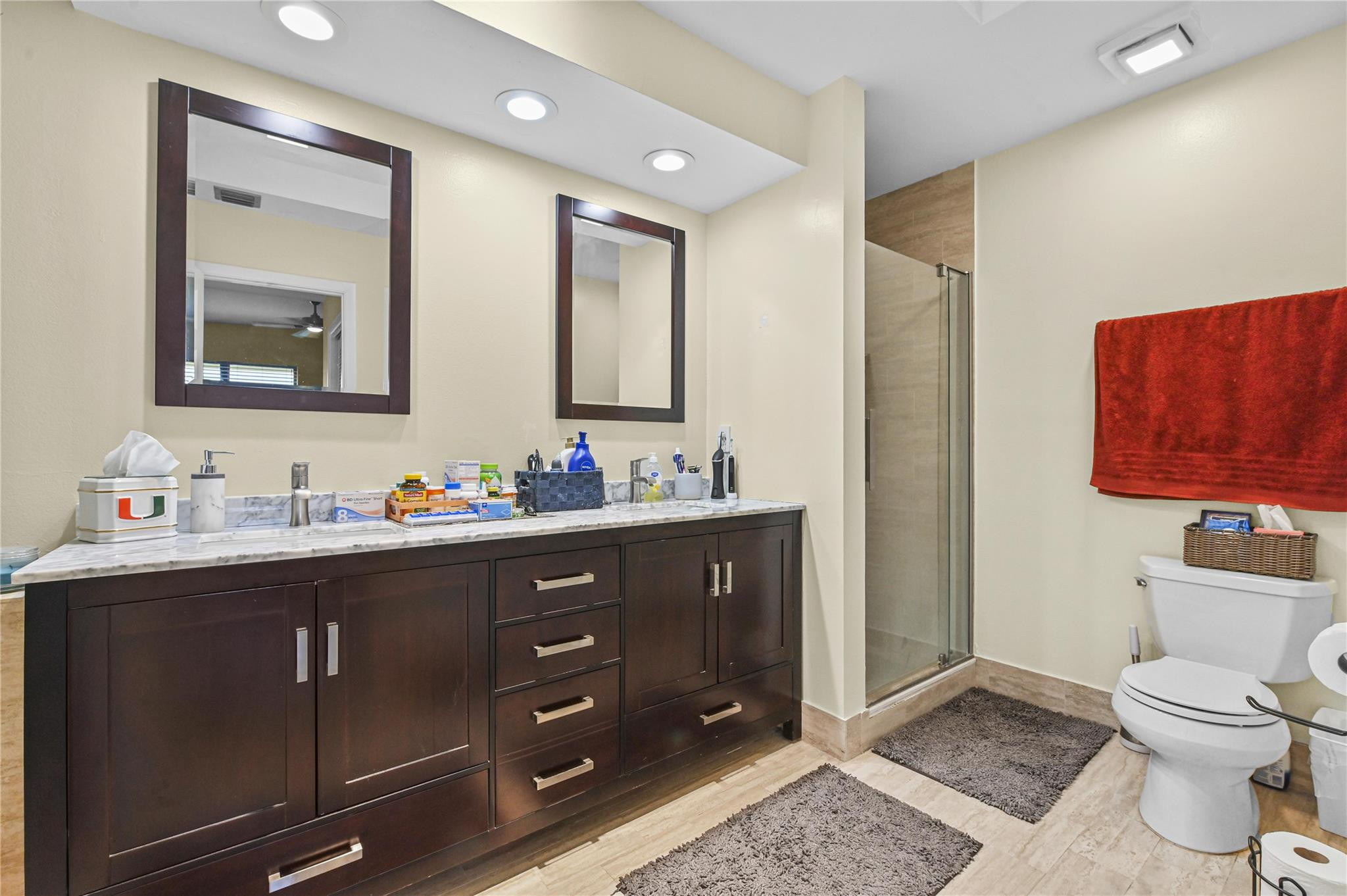 7520 La Paz Boulevard, Unit 306 Boca Raton, FL 33433 - Photo 22 of 36 a bathroom with a toilet a sink and mirror