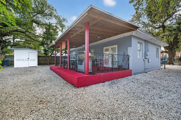 a view of a house with backyard and a tree
