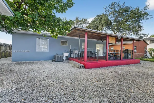 a view of a house with backyard and sitting area