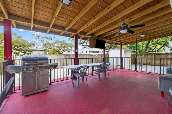 a view of a porch with chairs and backyard