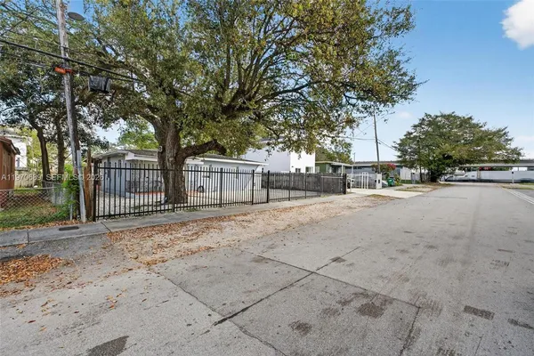 a view of road with a trees in the background