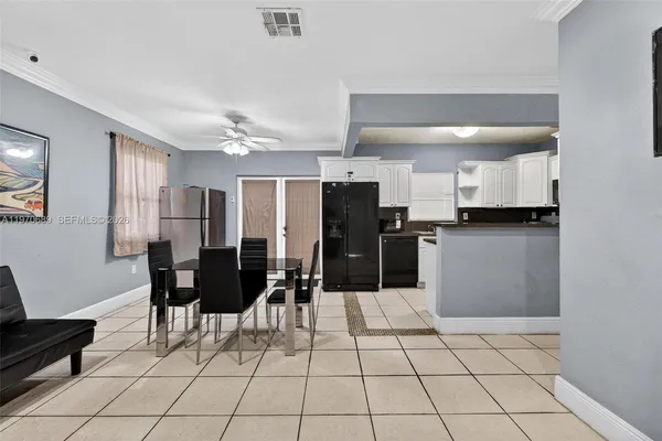 a kitchen with stainless steel appliances kitchen island granite countertop a refrigerator and cabinets