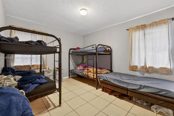 a bedroom with furniture and a window