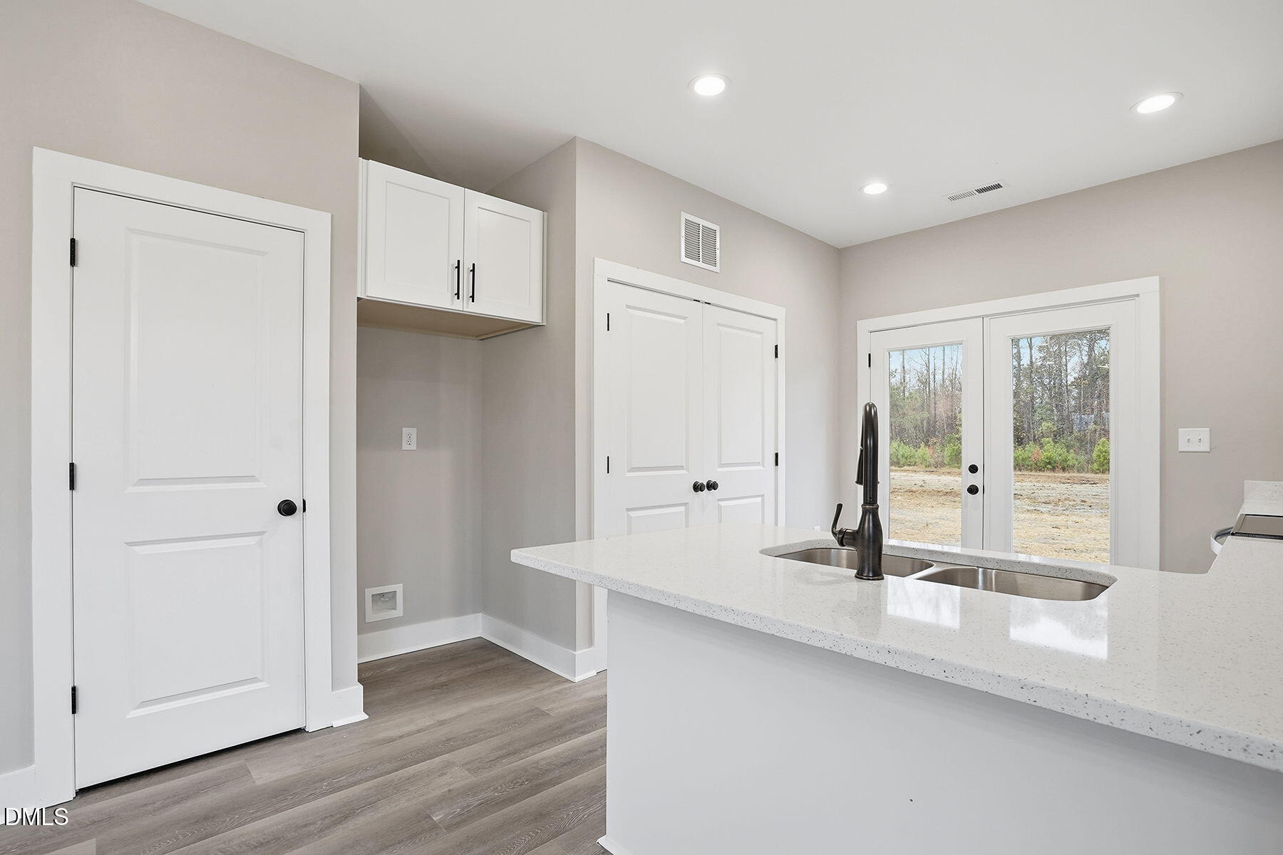 1029 Jada Allen Road Dunn, NC 28334 - Photo 11 of 31 a large white kitchen with a sink and wooden floor