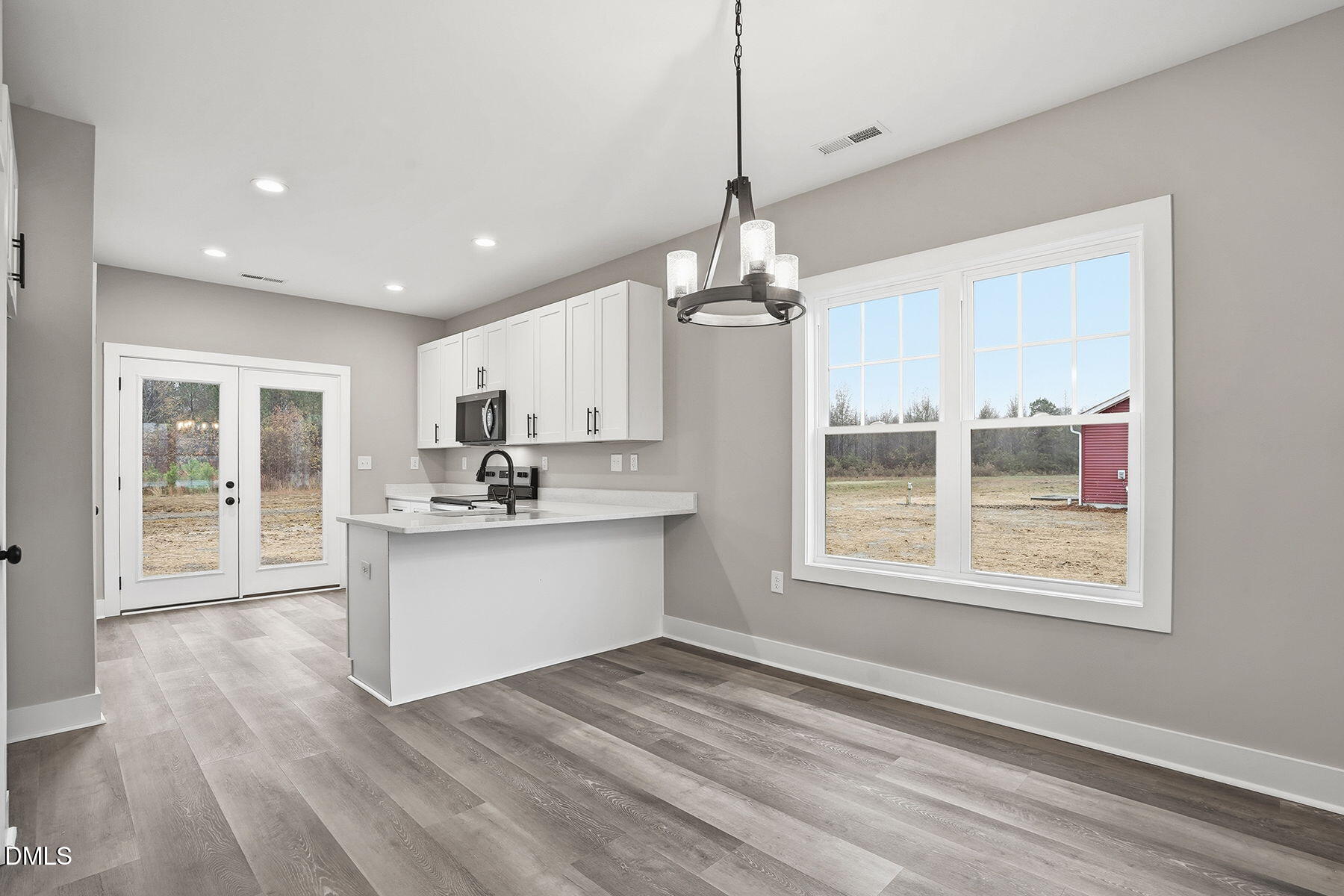 1029 Jada Allen Road Dunn, NC 28334 - Photo 8 of 31 a view of a kitchen with a sink hardwood floor and a large window