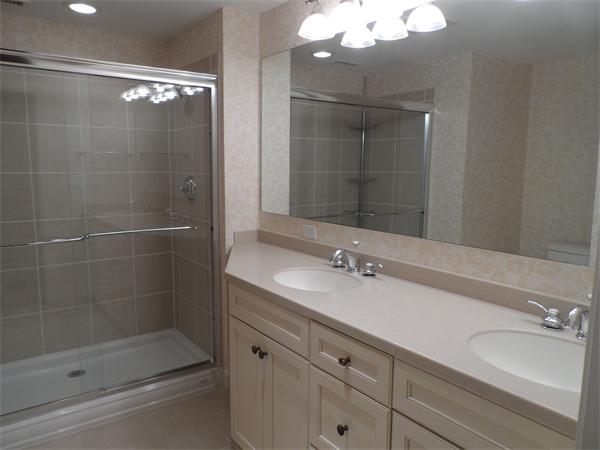 48 Jericho Road, Unit 48 Weston, MA 02493 - Photo 15 of 19 a bathroom with a shower sink and mirror