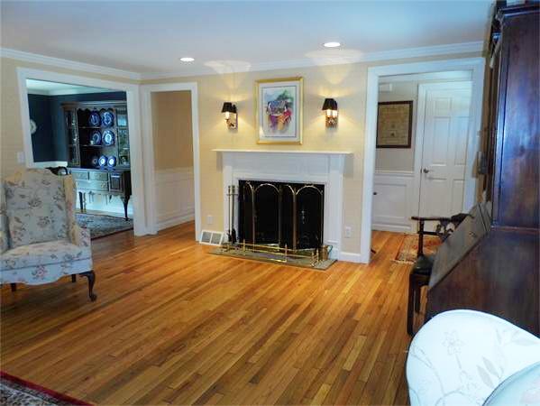 48 Jericho Road, Unit 48 Weston, MA 02493 - Photo 5 of 19 a view of livingroom with furniture wooden floor and a fireplace