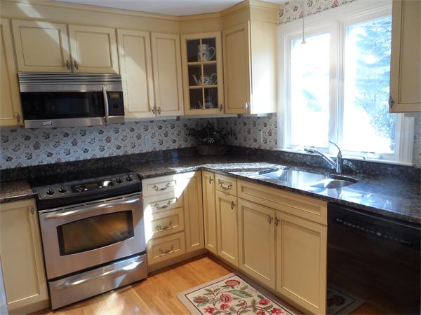48 Jericho Road, Unit 48 Weston, MA 02493 - Photo 9 of 19 a kitchen with stainless steel appliances a stove sink and microwave