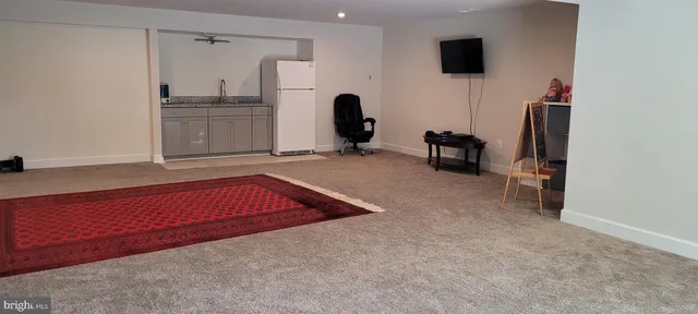 a view of a livingroom with furniture and a flat screen tv