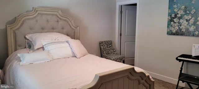 a bed room with a bed and a chair