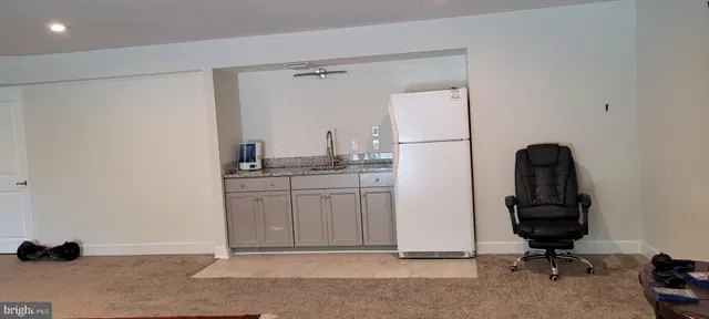 a kitchen with a refrigerator and cabinets