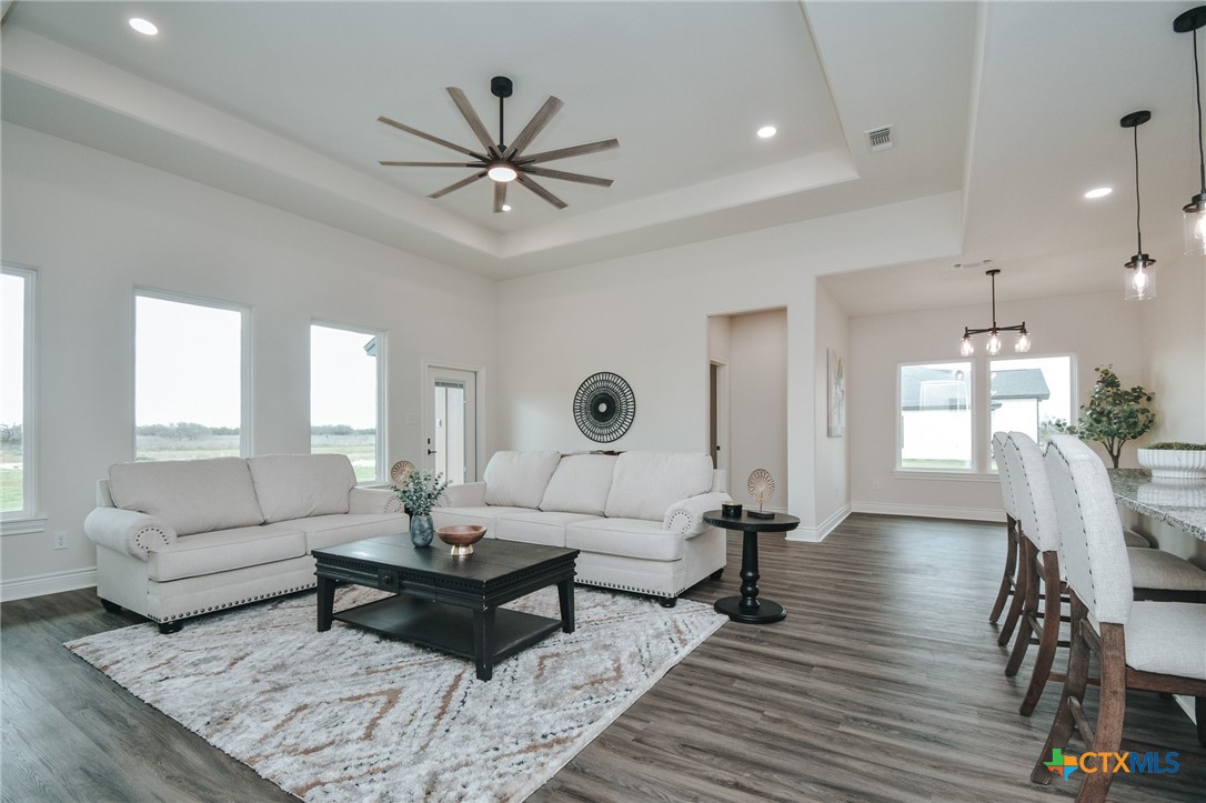 321 Whitetail Lane Victoria, TX 77905 - Photo 13 of 47 a living room with furniture a rug and a chandelier