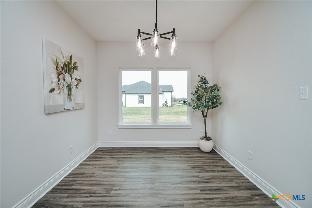 321 Whitetail Lane Victoria, TX 77905 - Photo 19 of 47 a view of empty room with window and wooden floor