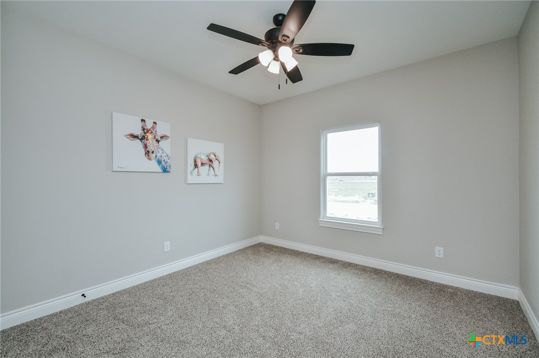 321 Whitetail Lane Victoria, TX 77905 - Photo 23 of 47 an empty room with a window and a fan