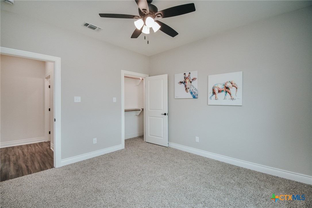 321 Whitetail Lane Victoria, TX 77905 - Photo 24 of 47 an empty room with closet and a chandelier fan