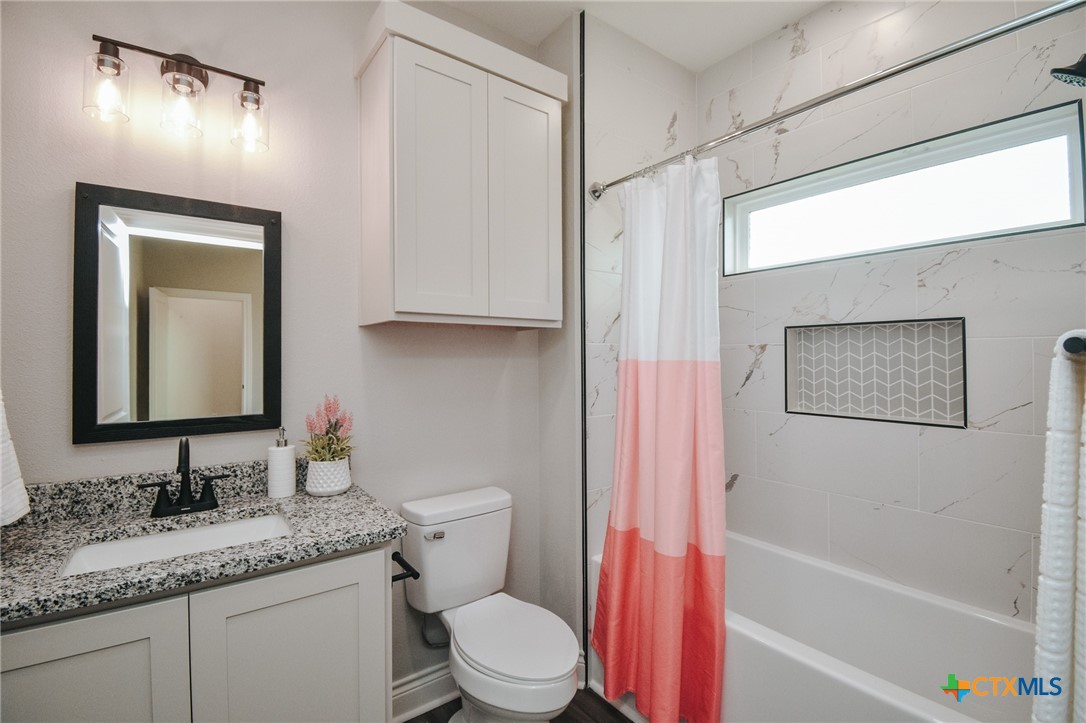 321 Whitetail Lane Victoria, TX 77905 - Photo 30 of 47 a bathroom with a granite countertop sink toilet and shower
