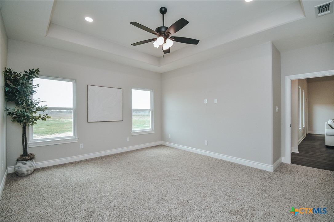 321 Whitetail Lane Victoria, TX 77905 - Photo 37 of 47 an empty room with windows and ceiling fan