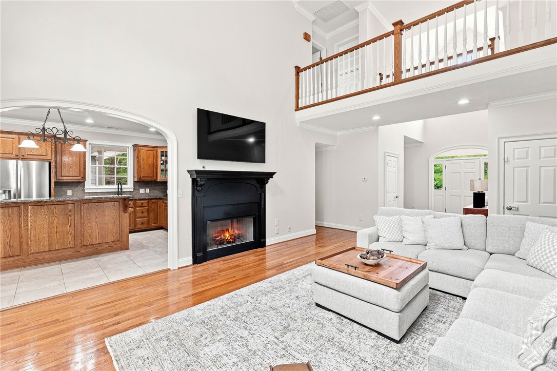 320 Watson Road Easley, SC 29642 - Photo 11 of 50 Gleaming hardwood floors and a towering hearth frame this double-height living room layout.