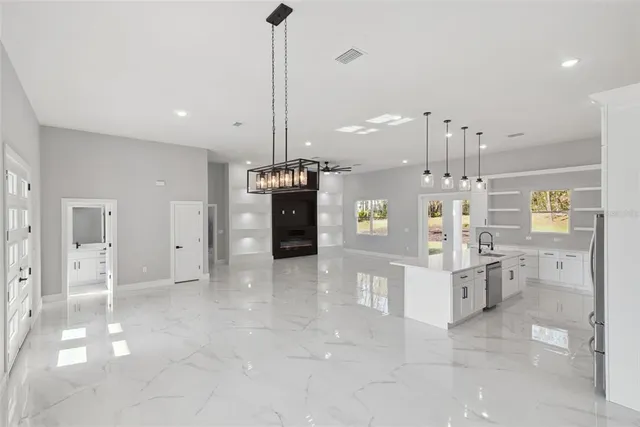 a view of a kitchen with refrigerator and window