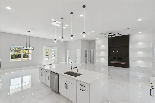 a large kitchen with kitchen island a sink stainless steel appliances and cabinets