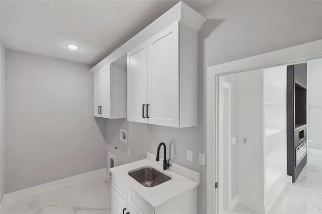 a kitchen with stainless steel appliances granite countertop a sink and a refrigerator