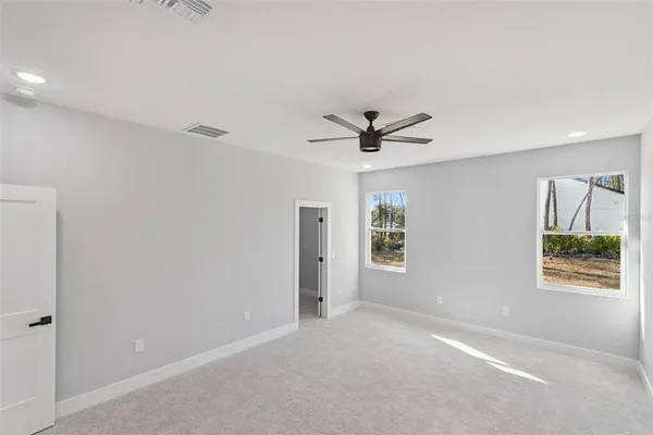 a view of a livingroom with a ceiling fan and window
