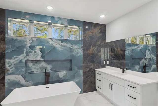 a bathroom with a sink a mirror and a bathtub