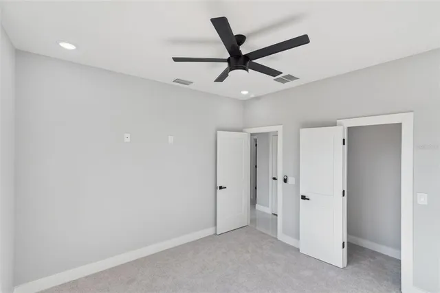 an empty room with ceiling fan
