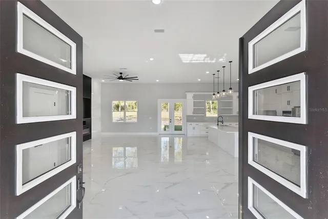 a view of a hallway with wooden floor and staircase