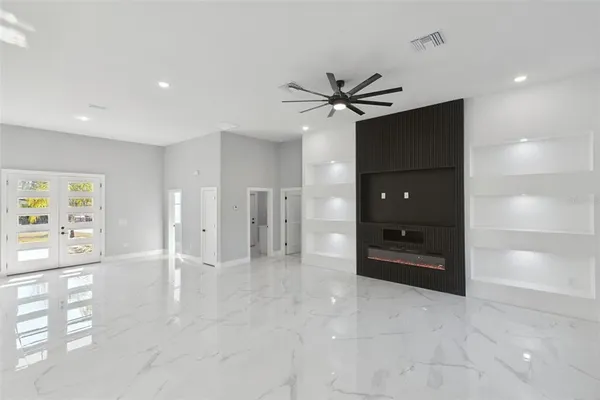 a view of a hallway with a bedroom and a ceiling fan