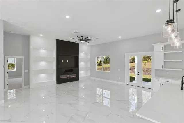 a view of a hallway with wooden floor and windows