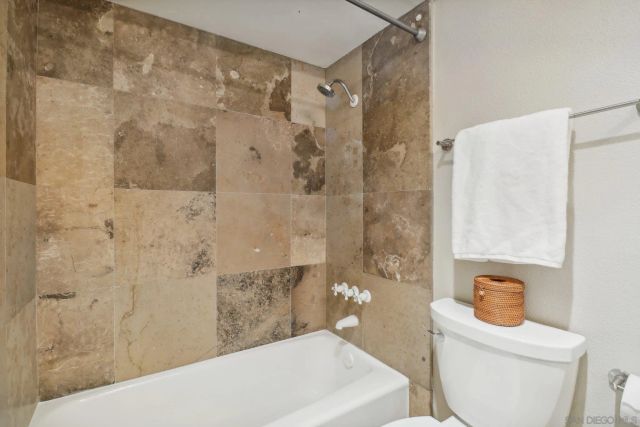 a spacious bedroom with a bed and a couch