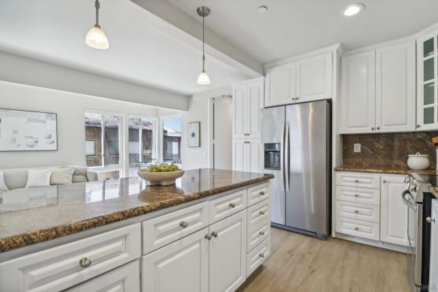 a kitchen with cabinets appliances and a counter space