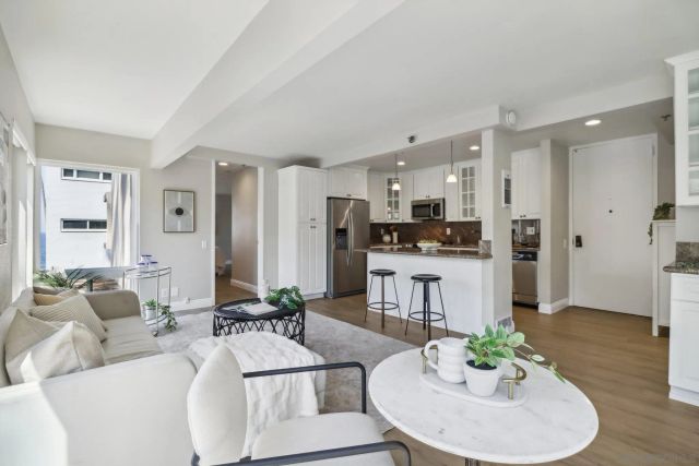 a living room with kitchen island furniture and a wooden floor