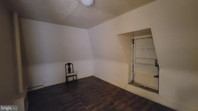 a room with a bench and wooden floor