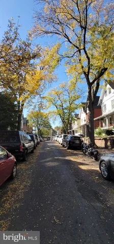 a city street lined with buildings and trees