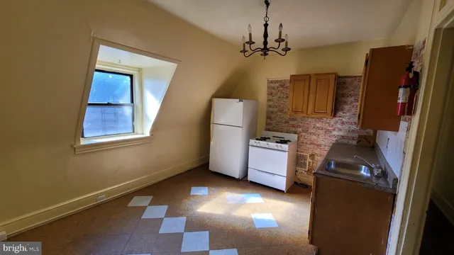 a kitchen with stainless steel appliances a refrigerator and a stove top oven