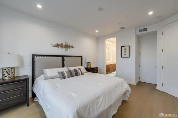 a bedroom with a bed and a night stand
