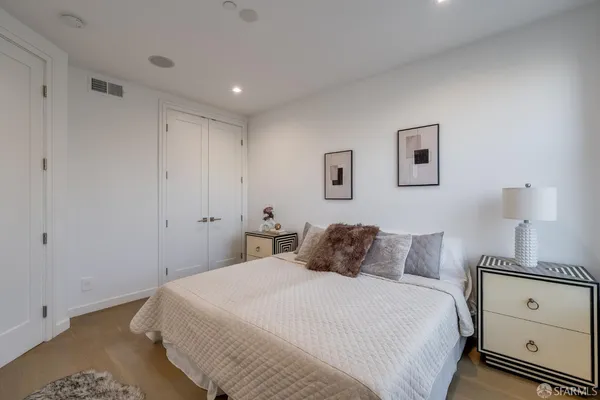a bedroom with a bed and a night stand