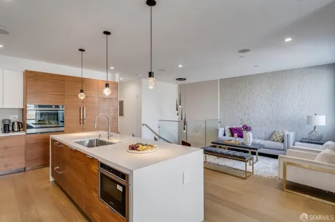 a kitchen that has a stove and a wooden floor