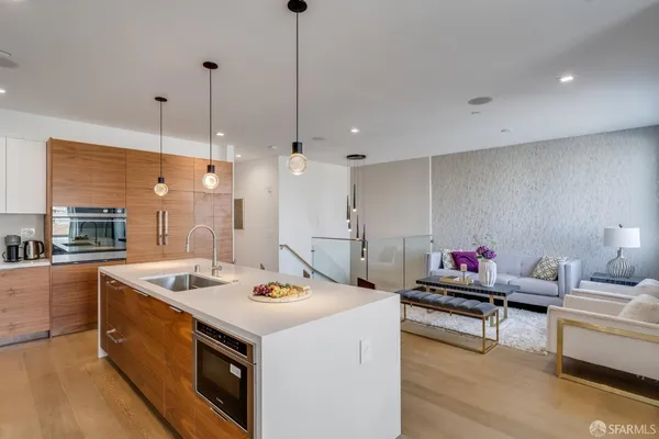 a kitchen that has a stove and a wooden floor