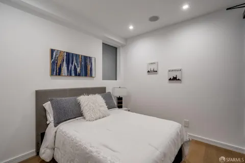 a bedroom with a bed and a wall painting