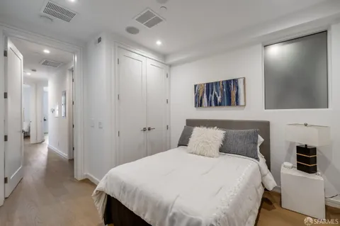 a bedroom with a large bed and a flat screen tv