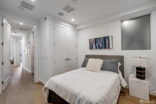 a bedroom with a large bed and a flat screen tv