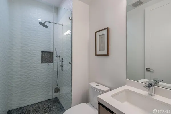 a bathroom with a sink toilet and shower